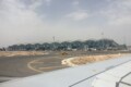 Alicante-Elche Airport terminal building seen from the runway with planes at the gates