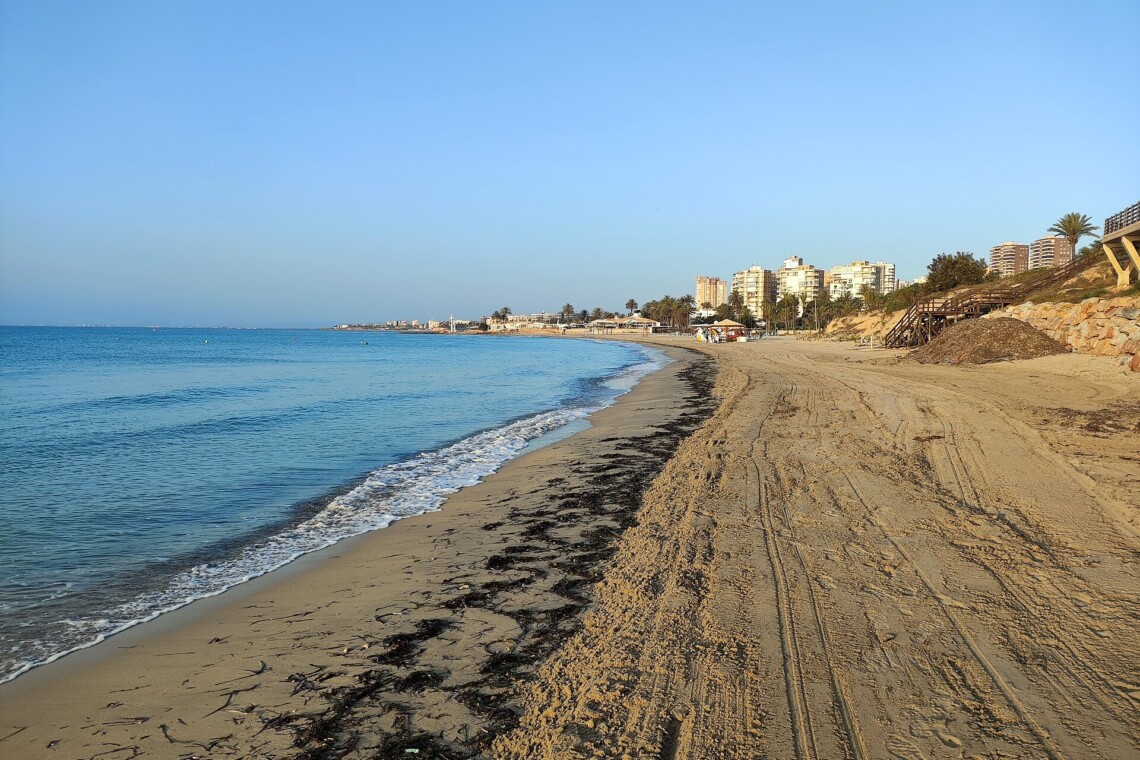 Playa de La Glea beach in Campoamor with golden sand and calm blue sea