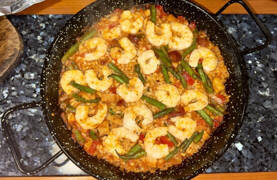Traditional Spanish mixed paella pan with prawns and green beans