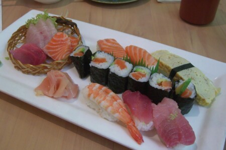Mixed sushi and sashimi platter with salmon, tuna, prawn nigiri and maki rolls
