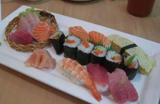 Mixed sushi and sashimi platter with salmon, tuna, prawn nigiri and maki rolls