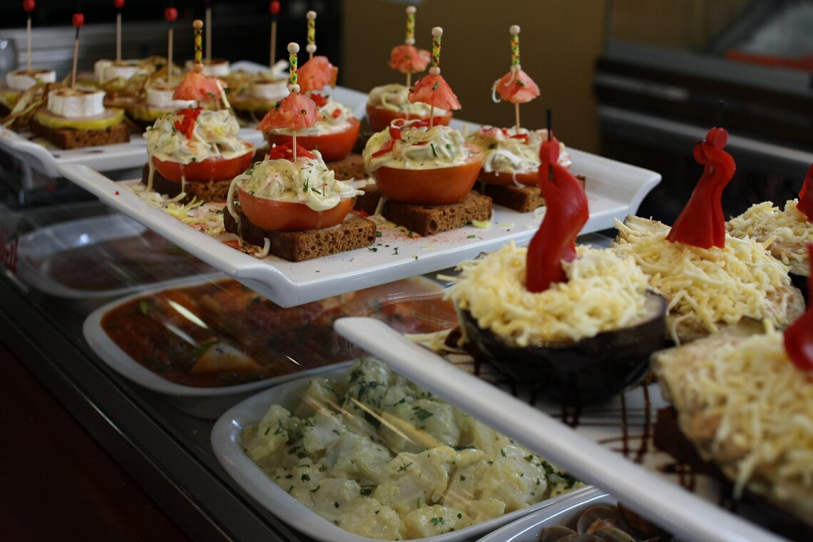 Spanish tapas and pinchos displayed on the counter of a tapas bar