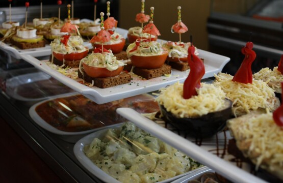 Spanish tapas and pinchos displayed on the counter of a tapas bar