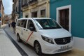 White Spanish taxi minivan waiting on a narrow street on the Costa Blanca