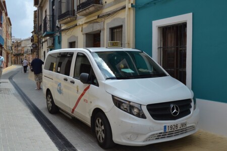 White Spanish taxi minivan waiting on a narrow street on the Costa Blanca