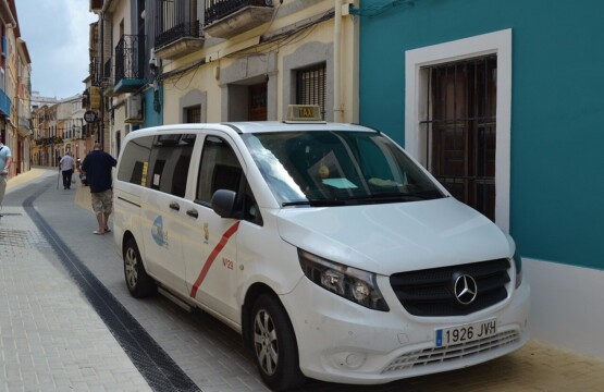 White Spanish taxi minivan waiting on a narrow street on the Costa Blanca